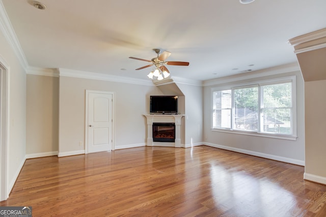 476 Walnut Rd, Hoschton, GA 30548 - unfurnished living room with a ceiling fan, a glass covered fireplace, light wood-style floors, and ornamental molding