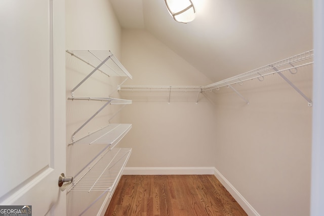 476 Walnut Rd, Hoschton, GA 30548 - walk in closet featuring vaulted ceiling and wood finished floors