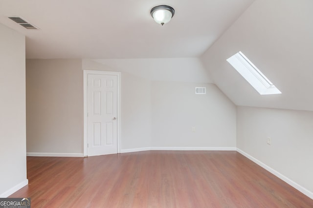 476 Walnut Rd, Hoschton, GA 30548 - bonus room with a skylight, wood finished floors, and vaulted ceiling