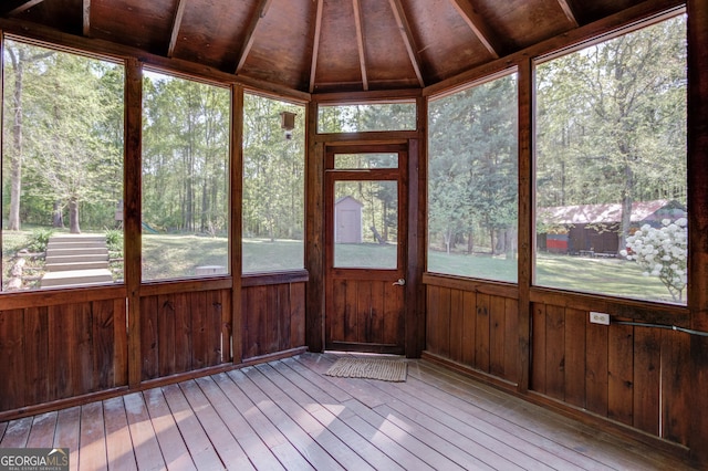 476 Walnut Rd, Hoschton, GA 30548 - unfurnished sunroom featuring hardwood / wood-style flooring, a wooden deck, wood walls, healthy amount of natural light, and vaulted ceiling