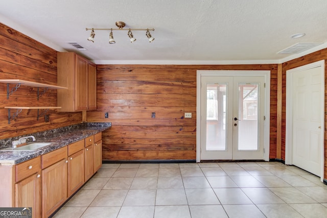 476 Walnut Rd, Hoschton, GA 30548 - kitchen featuring french doors, wooden walls, a textured ceiling, and dark stone countertops