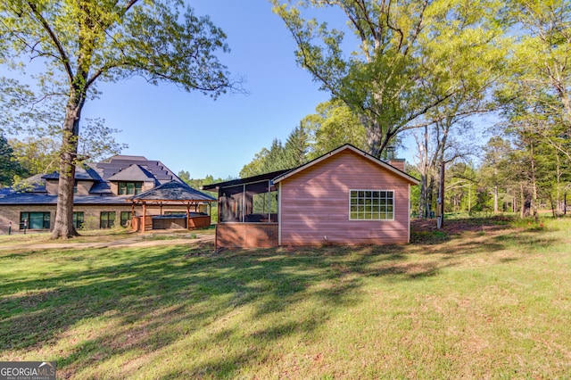 476 Walnut Rd, Hoschton, GA 30548 - rear view of property with a sunroom, a gazebo, a yard, a hot tub, and a chimney