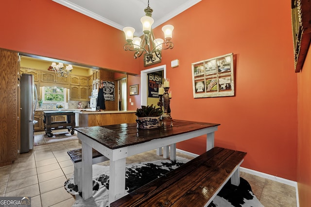 dining room with crown molding, an inviting chandelier, baseboards, and light tile patterned floors
