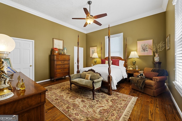 bedroom featuring baseboards, multiple windows, crown molding, and wood finished floors