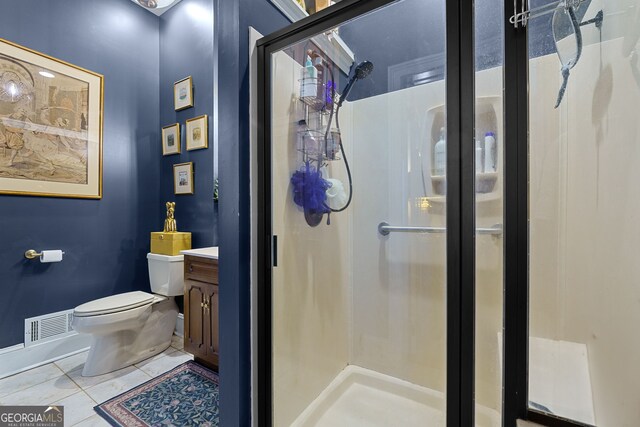 bathroom featuring a shower stall, vanity, visible vents, and toilet
