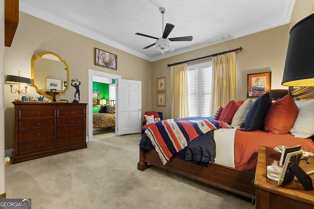 bedroom featuring a textured ceiling, crown molding, a ceiling fan, and carpet floors
