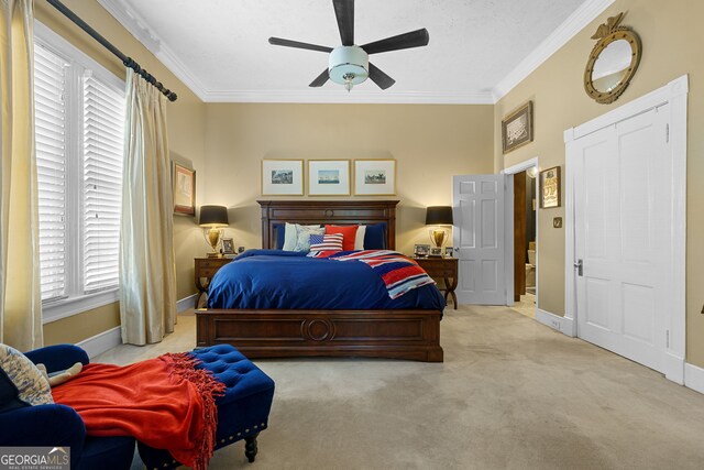 bedroom featuring ceiling fan, crown molding, carpet flooring, and baseboards