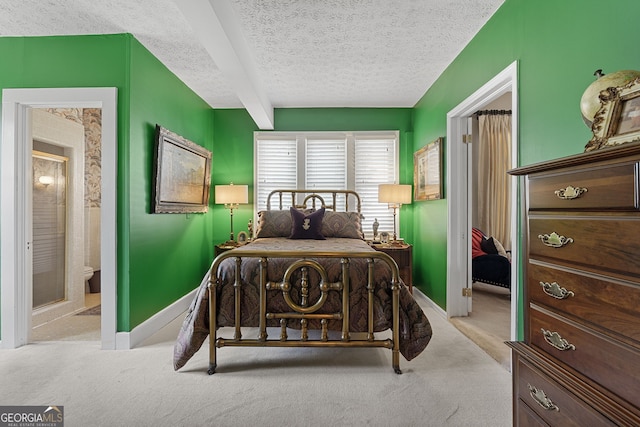 carpeted bedroom featuring beamed ceiling, ensuite bath, a textured ceiling, and baseboards