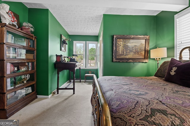 carpeted bedroom with baseboards and a textured ceiling