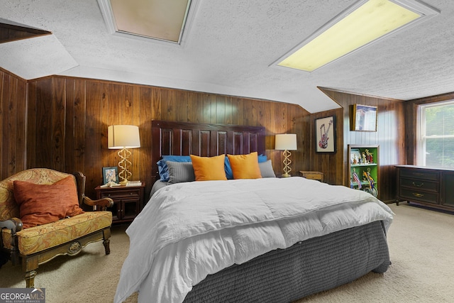carpeted bedroom with a textured ceiling, wooden walls, and vaulted ceiling