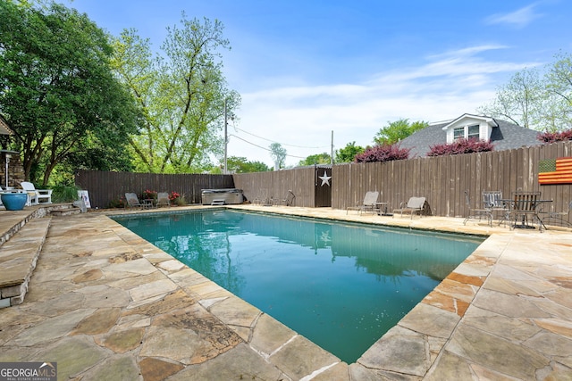 view of pool featuring a patio, a fenced backyard, and a fenced in pool