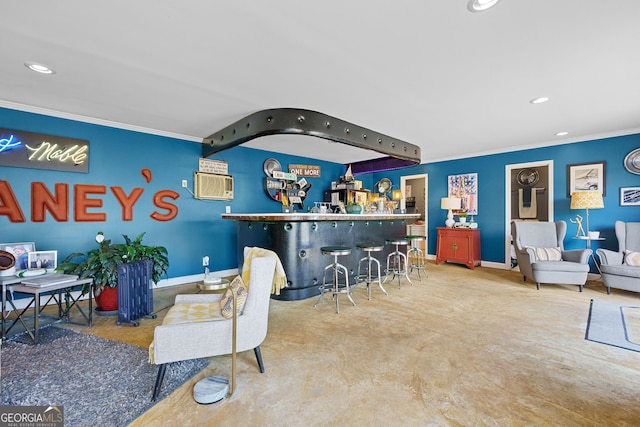 interior space with recessed lighting, baseboards, ornamental molding, and a dry bar