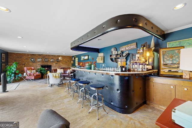 bar featuring brick wall, recessed lighting, finished concrete floors, and a brick fireplace