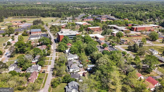 birds eye view of property featuring a wooded view