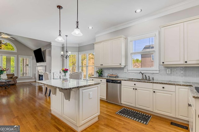 895 Ovalene Ln SW, Marietta, GA 30064 - kitchen featuring dishwasher, open floor plan, a fireplace, decorative backsplash, and light stone counters