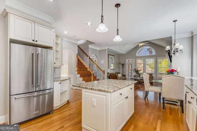895 Ovalene Ln SW, Marietta, GA 30064 - kitchen with high end fridge, open shelves, light wood finished floors, pendant lighting, and crown molding