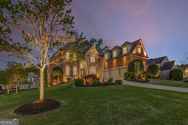 895 Ovalene Ln SW, Marietta, GA 30064 - view of front facade with an attached garage, a lawn, brick siding, driveway, and stone siding