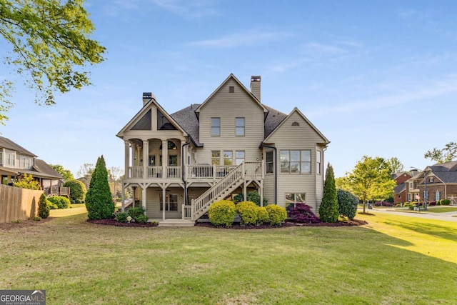 895 Ovalene Ln SW, Marietta, GA 30064 - back of house with a chimney, stairs, covered porch, and a balcony