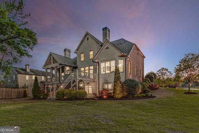 895 Ovalene Ln SW, Marietta, GA 30064 - back of property at dusk featuring a chimney and a wooden deck