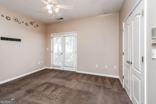 empty room with carpet, visible vents, french doors, and ceiling fan