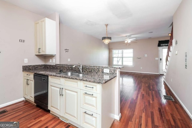 kitchen with dark wood-style flooring, a peninsula, a ceiling fan, dishwasher, and a sink