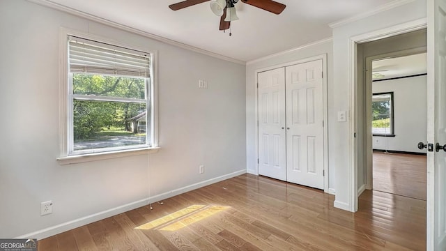 unfurnished bedroom featuring ornamental molding, baseboards, and multiple windows
