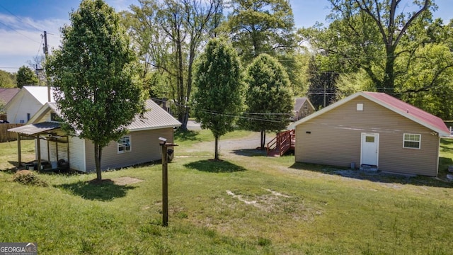 view of yard featuring entry steps and an outbuilding