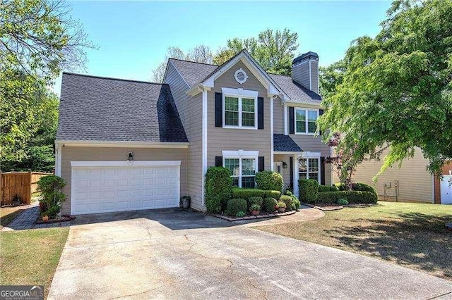 view of front facade featuring fence, driveway, a chimney, and an attached garage