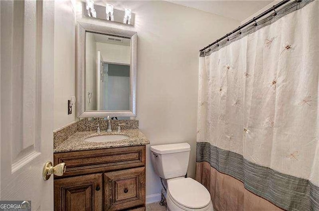 full bathroom with toilet, vanity, and a shower with curtain