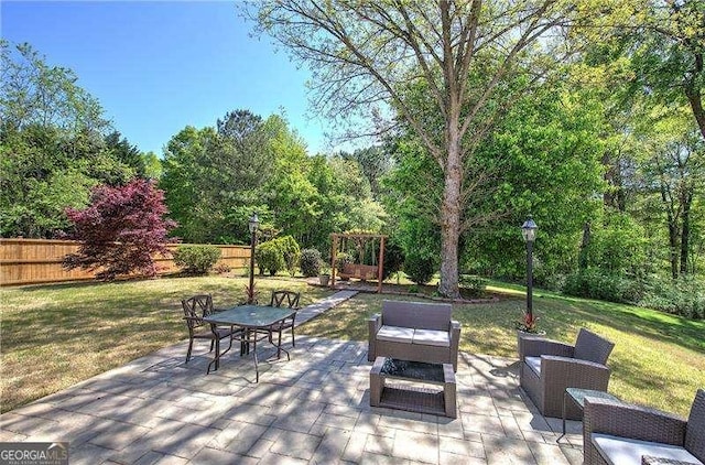 view of patio with fence and a fire pit
