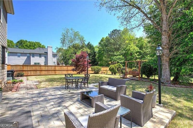 view of patio with outdoor lounge area, outdoor dining space, and a fenced backyard