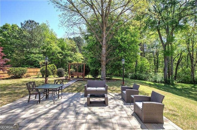 view of patio featuring outdoor lounge area and fence