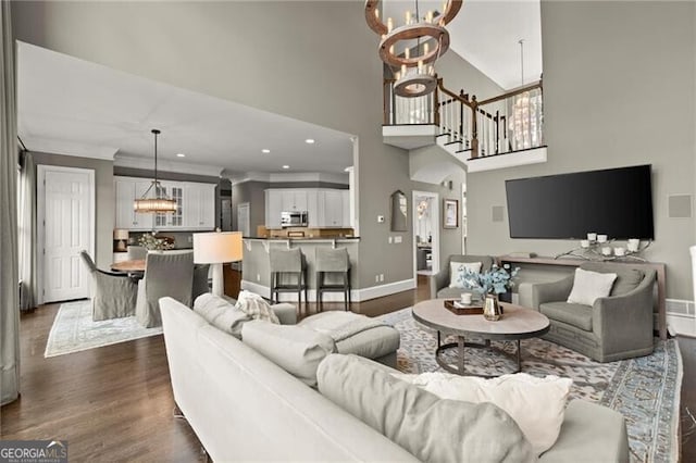 3749 Watkins Pl NE, Brookhaven, GA 30319 - living room featuring a chandelier, baseboards, dark wood-type flooring, a towering ceiling, and recessed lighting