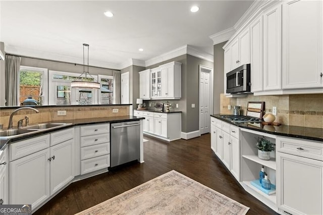 3749 Watkins Pl NE, Brookhaven, GA 30319 - kitchen featuring appliances with stainless steel finishes, a sink, dark countertops, crown molding, and backsplash