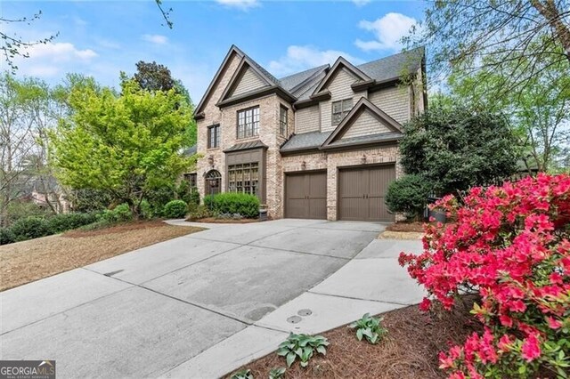 3749 Watkins Pl NE, Brookhaven, GA 30319 - view of front of home featuring driveway, an attached garage, and brick siding