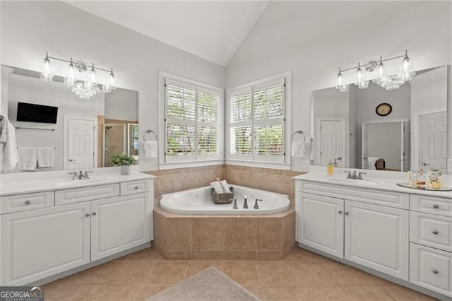 3749 Watkins Pl NE, Brookhaven, GA 30319 - full bath with two vanities, tile patterned floors, a bath, a shower stall, and high vaulted ceiling