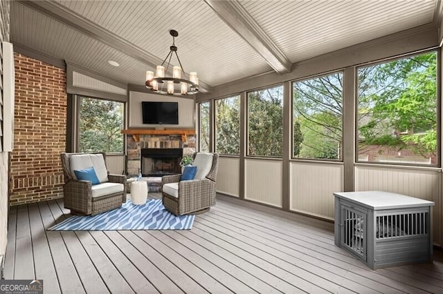 3749 Watkins Pl NE, Brookhaven, GA 30319 - sunroom with a stone fireplace, a chandelier, healthy amount of natural light, and beamed ceiling