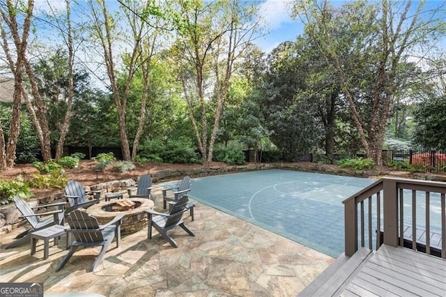 3749 Watkins Pl NE, Brookhaven, GA 30319 - view of swimming pool with an outdoor fire pit, view of wooded area, and a patio area