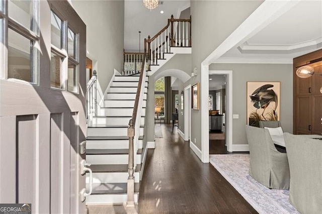 3749 Watkins Pl NE, Brookhaven, GA 30319 - foyer featuring stairway, dark wood-style floors, arched walkways, ornamental molding, and baseboards
