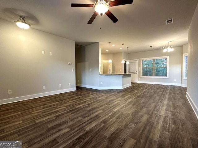 349 Park Blvd W, Athens, GA 30606 - unfurnished living room featuring dark wood finished floors, baseboards, ceiling fan, and a chandelier