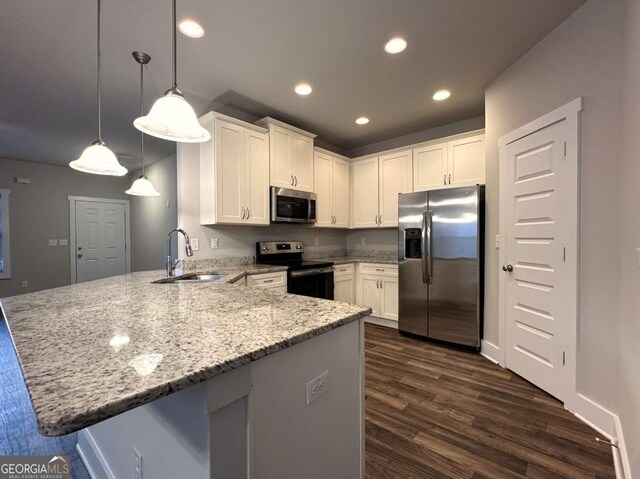 349 Park Blvd W, Athens, GA 30606 - kitchen with stainless steel appliances, a peninsula, light stone countertops, white cabinets, and recessed lighting