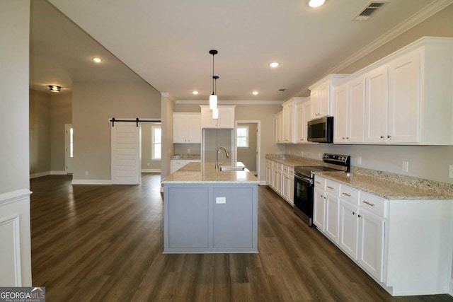 kitchen featuring dark wood finished floors, white cabinetry, visible vents, a barn door, and appliances with stainless steel finishes