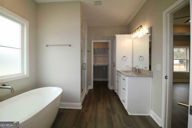 full bathroom featuring visible vents, baseboards, vanity, and wood finished floors