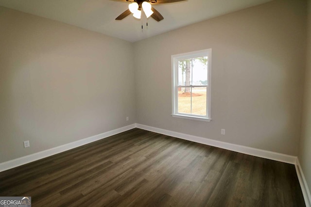 empty room with ceiling fan, baseboards, and dark wood finished floors