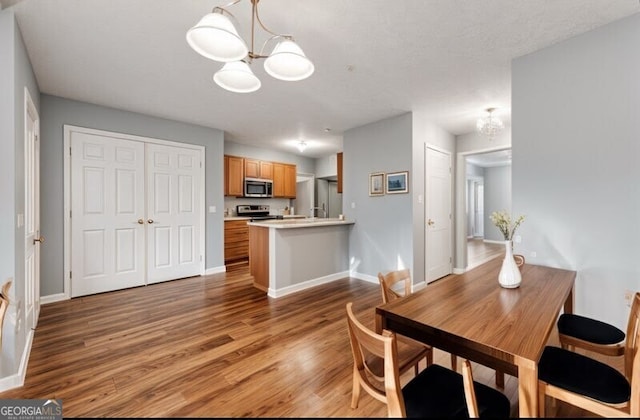 4413 Pinscher St, Union City, GA 30291 - dining area with baseboards, wood finished floors, and a notable chandelier