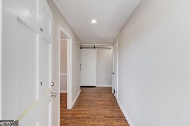 hallway with recessed lighting, wood finished floors, and baseboards