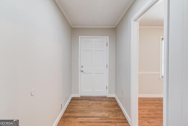 hallway featuring crown molding, visible vents, and wood finished floors