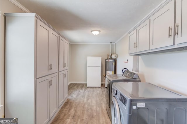 laundry room featuring light wood-style flooring, cabinet space, washing machine and clothes dryer, gas water heater, and crown molding