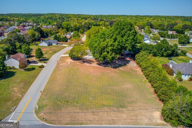 birds eye view of property with a residential view and a forest view