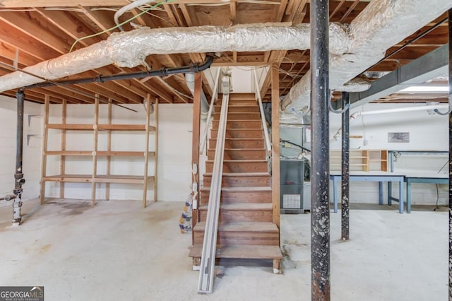 unfinished basement featuring stairs
